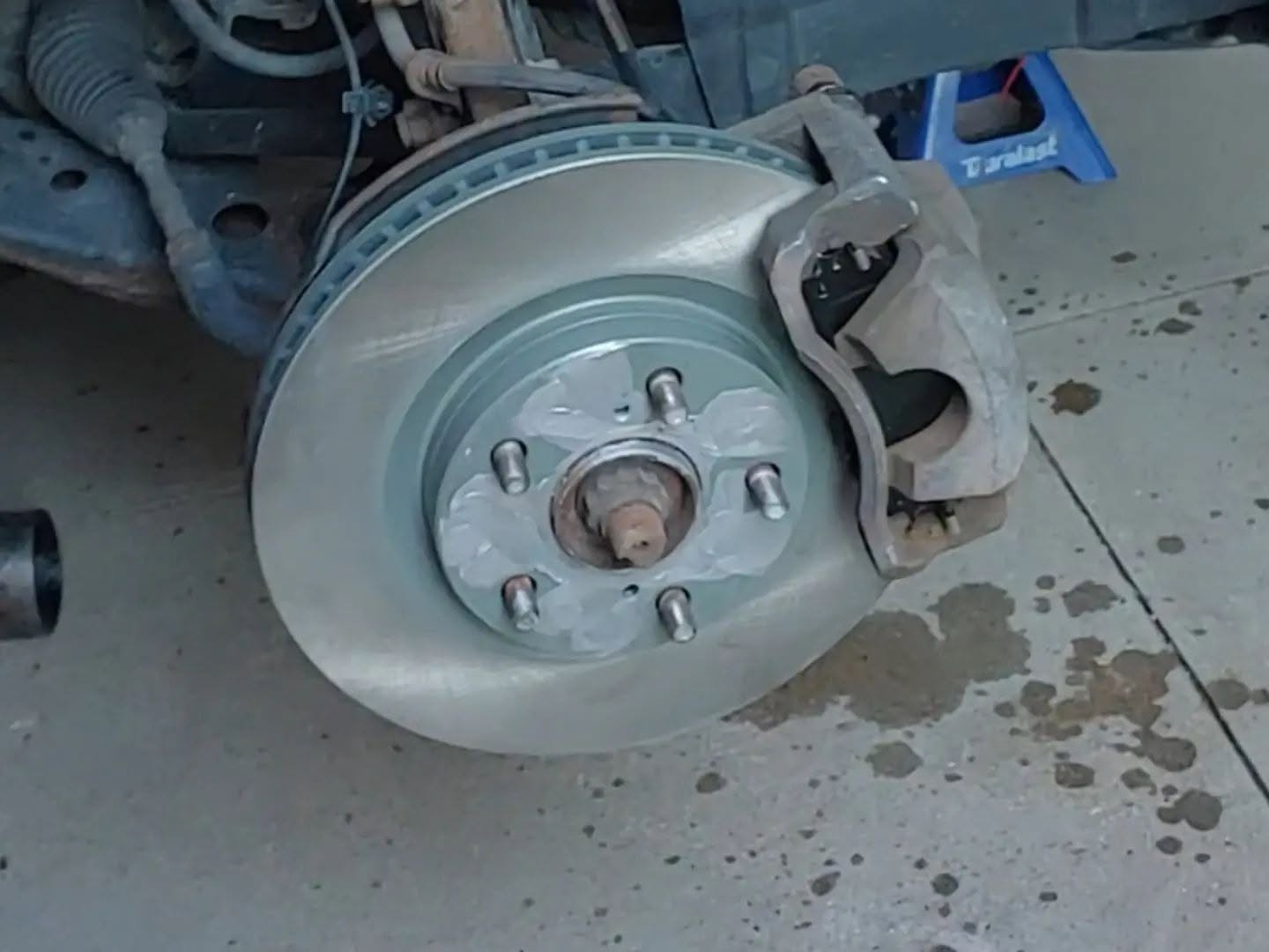 New brake rotor installed with caliper