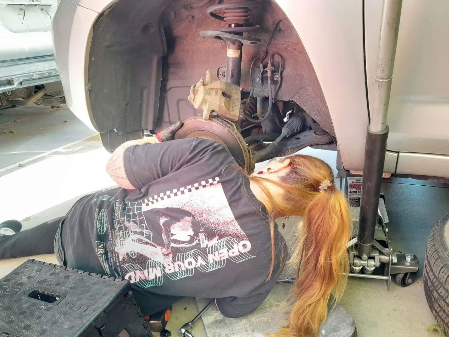Working under the wheel well on brake assembly